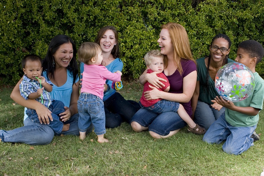 Community of mothers and their children playing.
